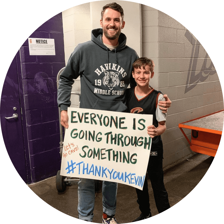 Kevin Love with Fan, Holding Sign That Says Everyone Is Going Through Something